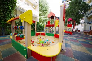 A playground with colorful play structures and a checkered floor. - SunMarInn Resort (Anapa)