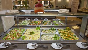 A buffet with various food options and serving utensils. - SunMarInn Resort (Anapa)
