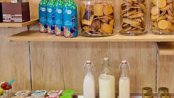 Shelves stocked with various food items including bottles, jars, and packaged goods.