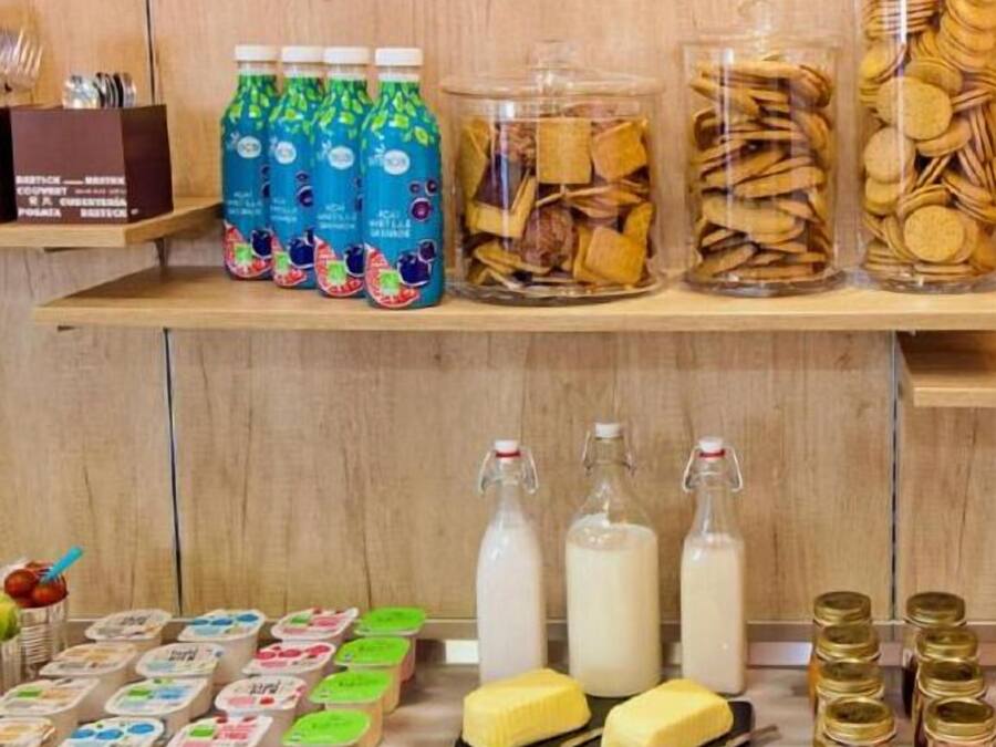 Shelves stocked with various food items including bottles, jars, and packaged goods.