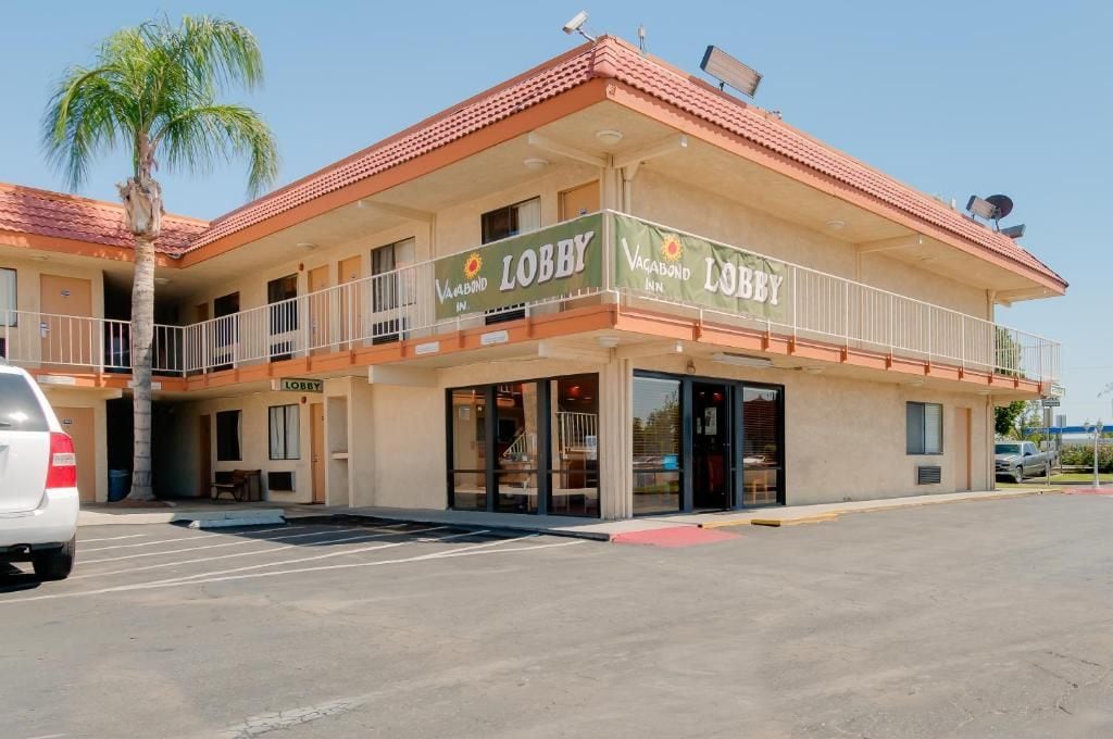 A two-story building with a balcony and a sign that reads 'Lobby.'