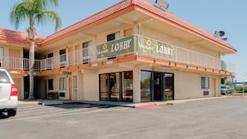 A two-story building with a balcony and a sign that reads 'Lobby.'