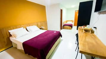 Superior Triple Room | Minibar, desk, laptop workspace, blackout drapes