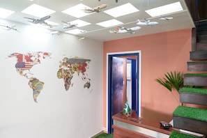 Explore the globe from our vibrant lobby, featuring a stunning world map mural and unique touches throughout.