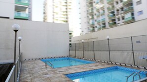 An indoor swimming pool with two lanes, surrounded by a tiled deck and a low wall. - Itaparica Praia Hotel (Vila Velha)