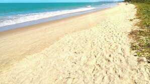 A beach with a clear sky and calm sea.