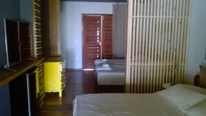 A bedroom with a bed, a wardrobe, and a door leading to another room. - Zebra Boutique Hotel (Beberibe)