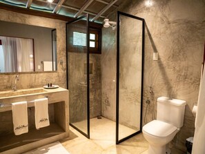 A modern bathroom with a glass-enclosed shower, a marble sink, and a white toilet. - Zebra Boutique Hotel (Beberibe)