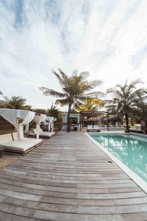 A wooden deck with lounge chairs and a pool. - Zebra Boutique Hotel (Beberibe)