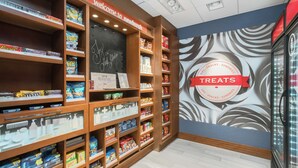 A snack display area with various packaged snacks and a sign indicating 'TREATS'.