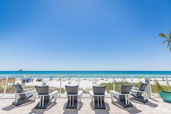 On the beach, white sand, sun loungers, beach umbrellas