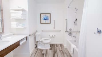 A modern bathroom with a toilet, sink, and shower.