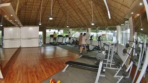 A gym with treadmills, weight benches, and barbells. - Villas del Palmar - Condo 704 (Manzanillo)