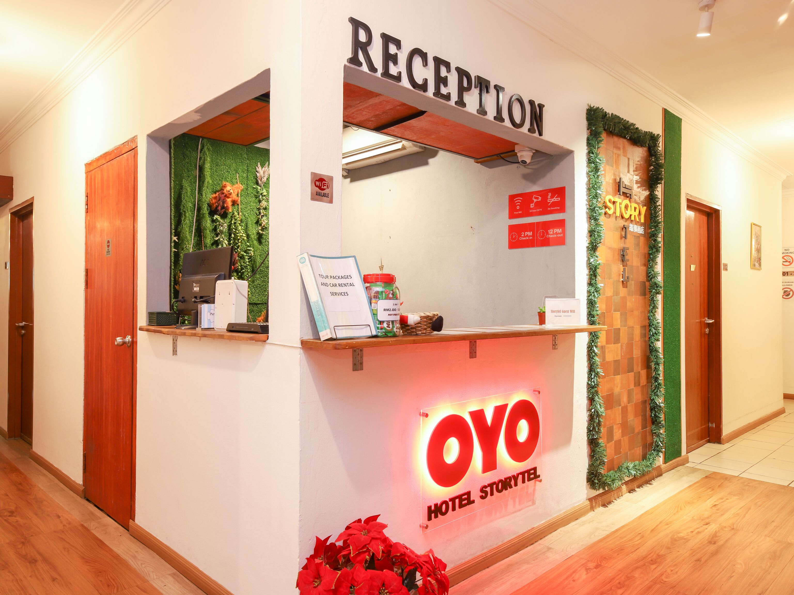 A reception desk with a sign reading "OYO HOTEL STORYTEL" and a "RECEPTION" sign above it.