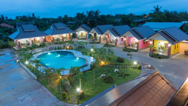 A resort with multiple villas, a central swimming pool, and well-maintained gardens. - Samrong Garden Resort (Udon Thani)