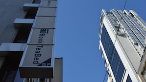 A building with a sign for 'BookTeaBed' on the side. - Book Tea Bed GINZA - Hostel (Tokyo)