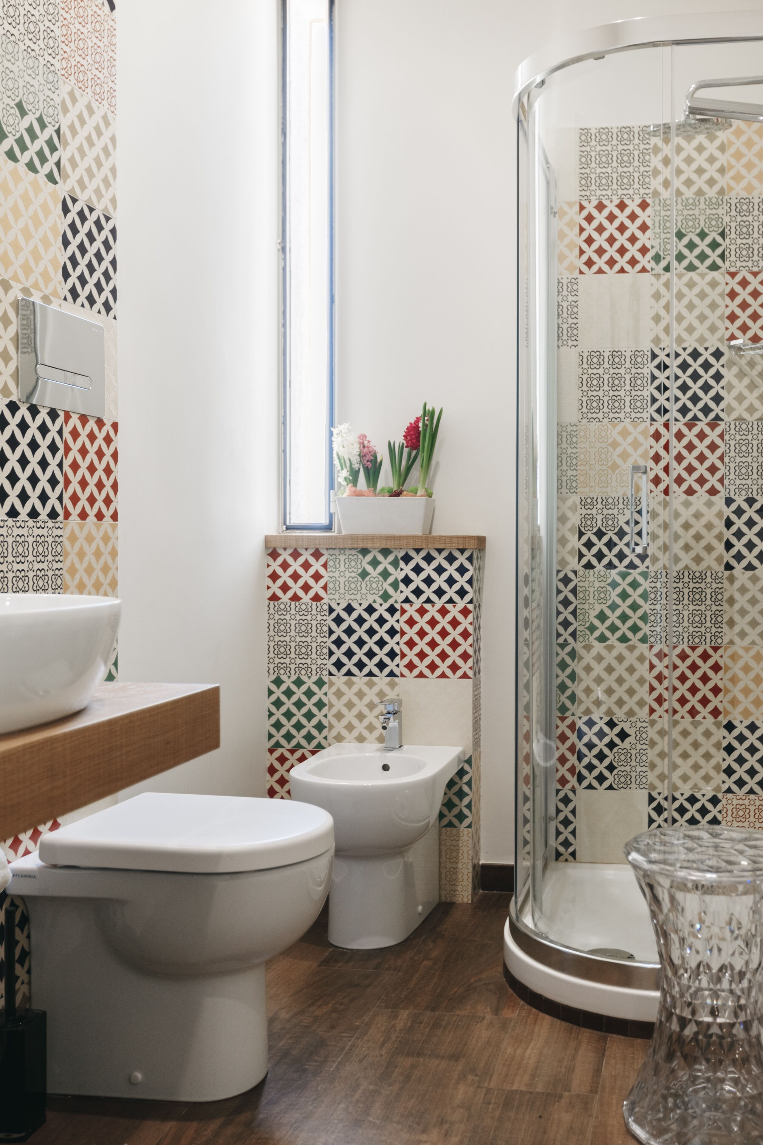 A modern bathroom with a toilet, bidet, and shower.
