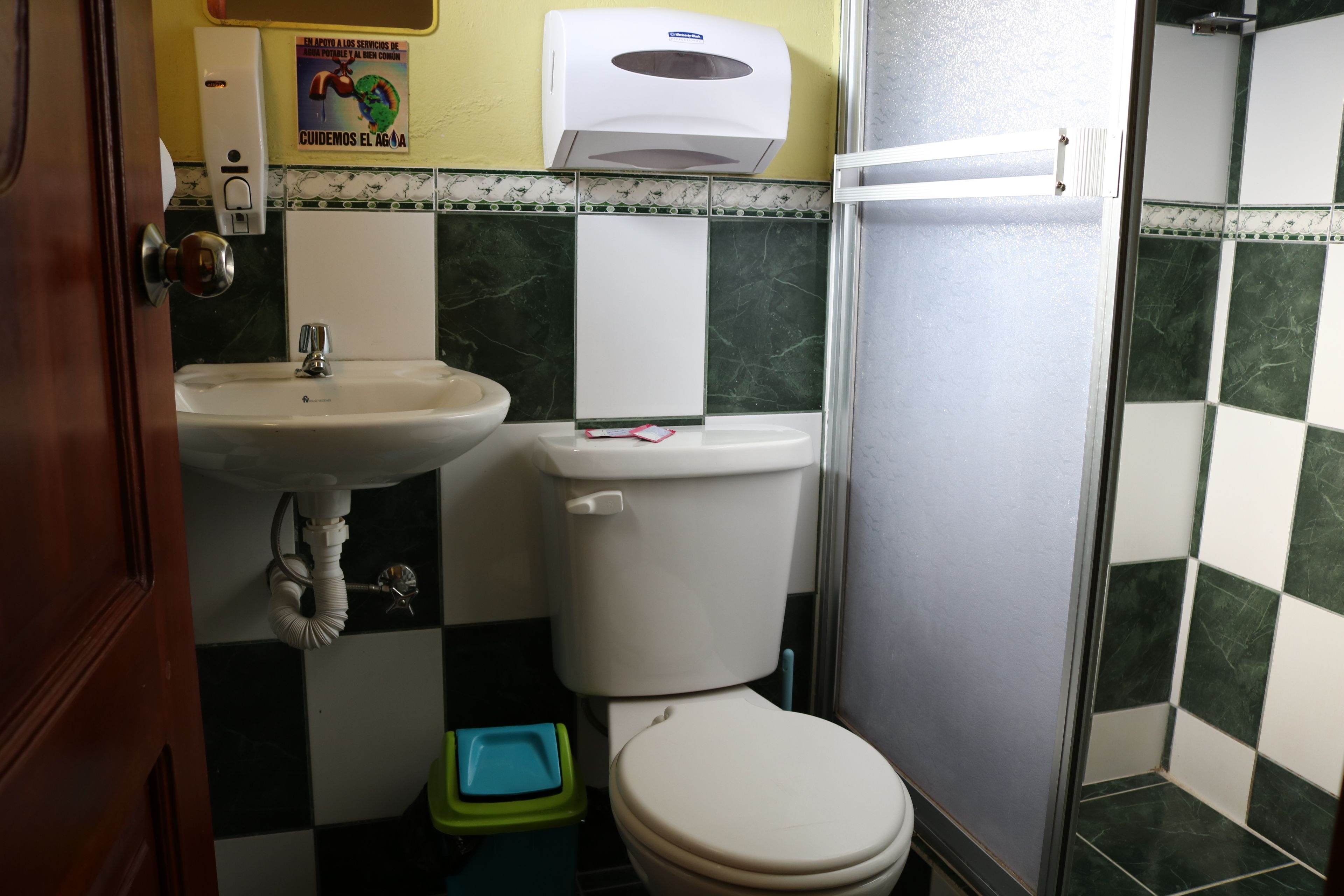 A bathroom with a sink, toilet, and shower.