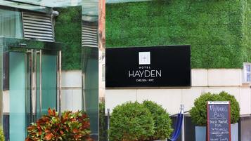 A hotel entrance with a sign for Hotel Hayden in Chelsea, NYC.