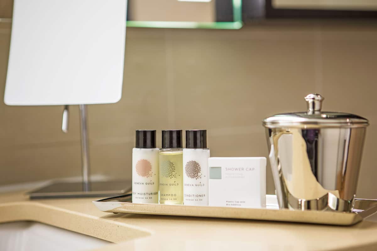 Shower, designer toiletries, hair dryer, towels