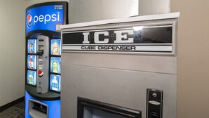 A vending machine with a Pepsi logo and a separate ice dispenser. - Red Roof Inn Cortland (Cortland)