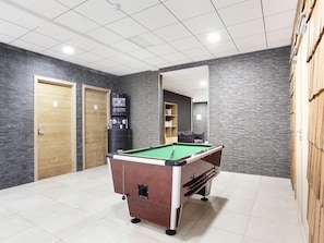 A pool table in a room with tiled flooring, a coffee machine, and a bookshelf. - Chalet in La Clusaz with Spa & Ski Access (La Clusaz)