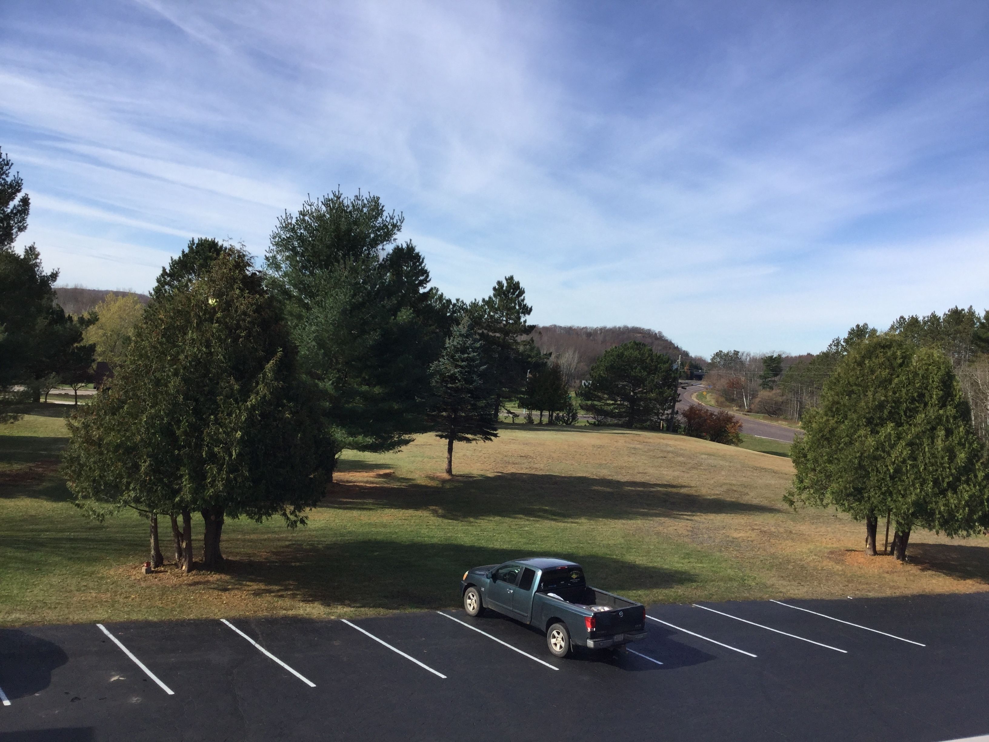 A parking lot with a single truck parked in one of the spaces.