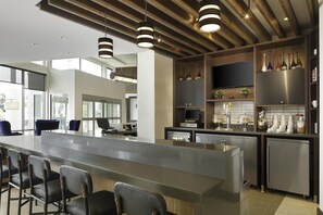 A modern kitchen with a large island, bar seating, and built-in appliances.