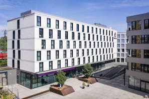 A modern building with a flat facade, multiple windows, and a central entrance. - Premier Inn Freiburg City Süd (Freiburg im Breisgau)