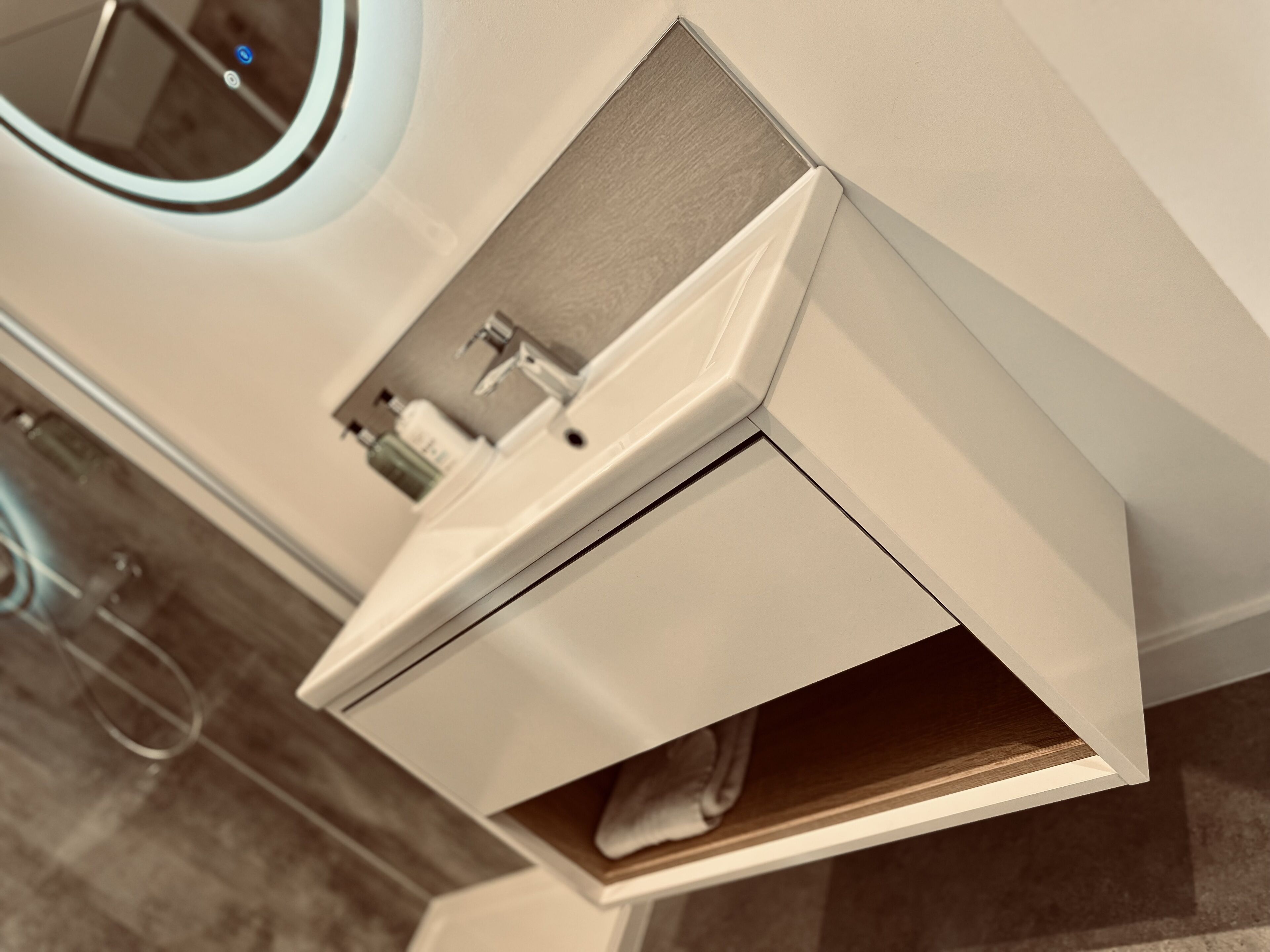 A modern bathroom with a sleek, white vanity and a built-in sink.