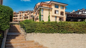 A multi-story residential building with a stone staircase leading to a gated entrance. - Menada Paradise Dreams Apartments (Sveti Vlas)
