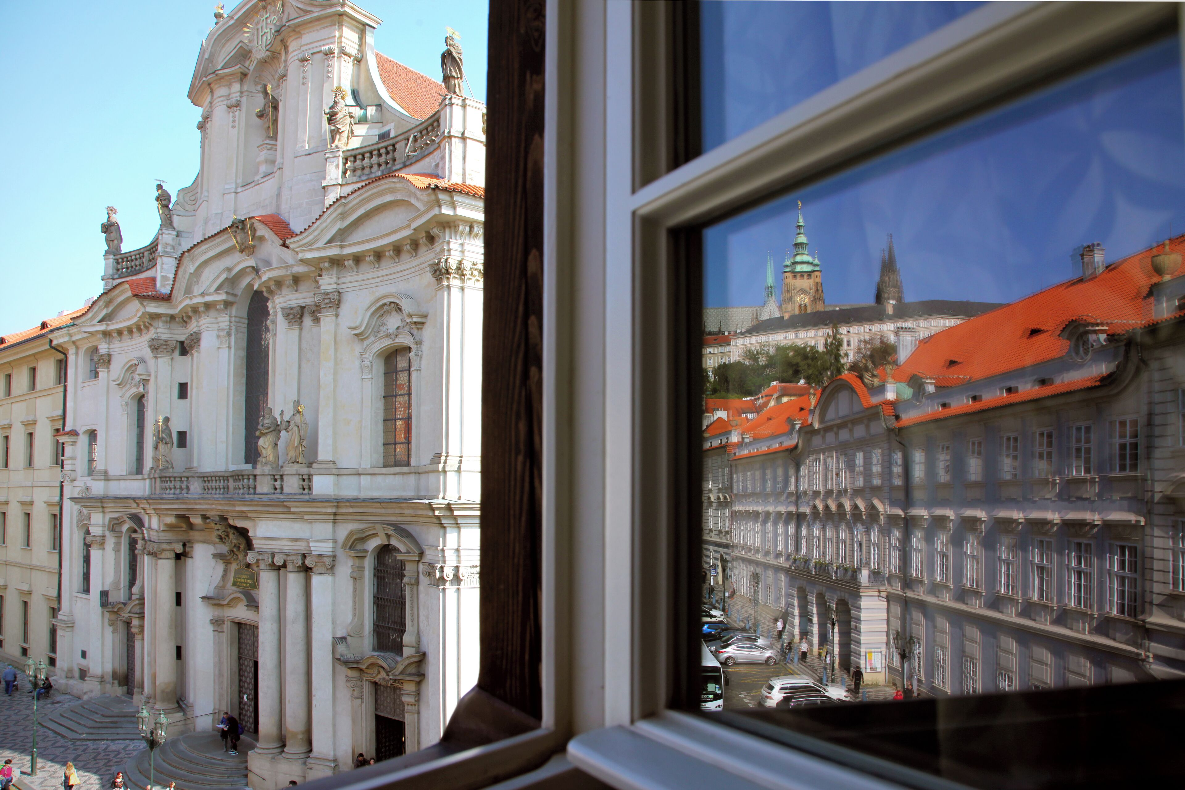 A building with ornate architecture, a prominent entrance, and a view through a window.
