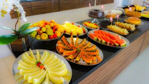 A buffet with various fruits and desserts.