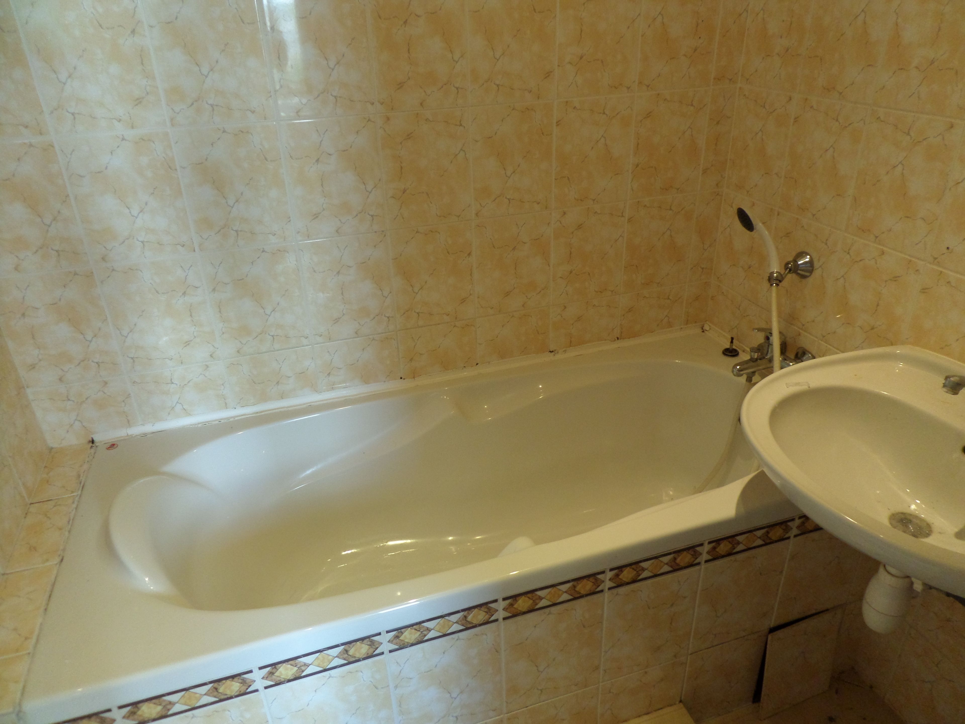 A bathroom with a bathtub and a sink.