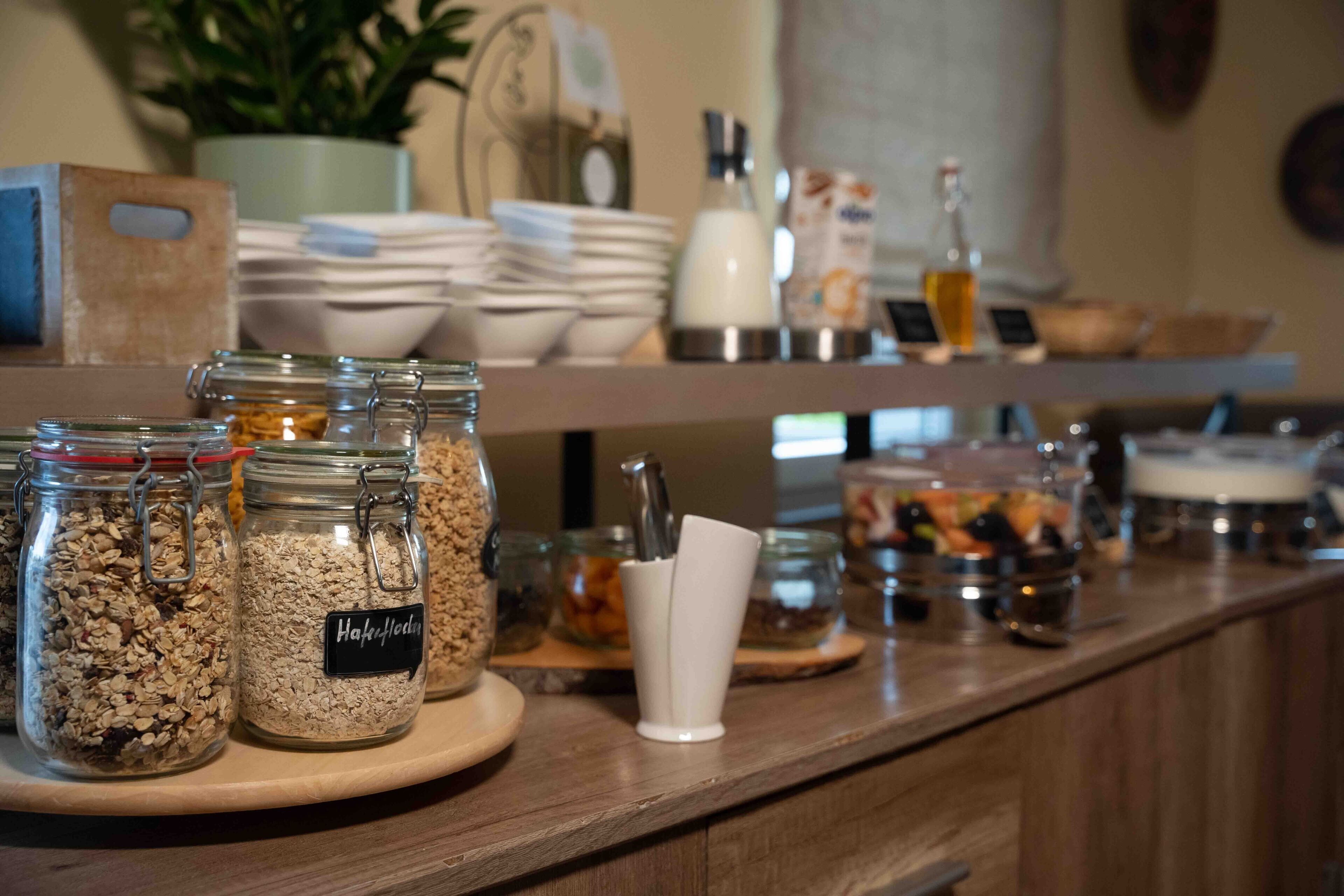 A breakfast bar with various food items and condiments.