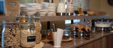 A breakfast bar with various food items and condiments.