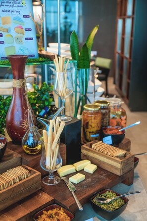 Enjoy a spread of international cuisine at our buffet, featuring a variety of dishes and condiments.