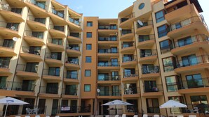 A multi-story hotel with balconies, outdoor seating, and a pool area. - Menada Amadeusz 1 Apartments (Sunny Beach)