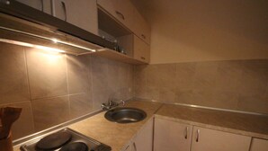 A kitchen with a stove, sink, and cabinets. - Menada Elit IV Apartments (Sunny Beach)