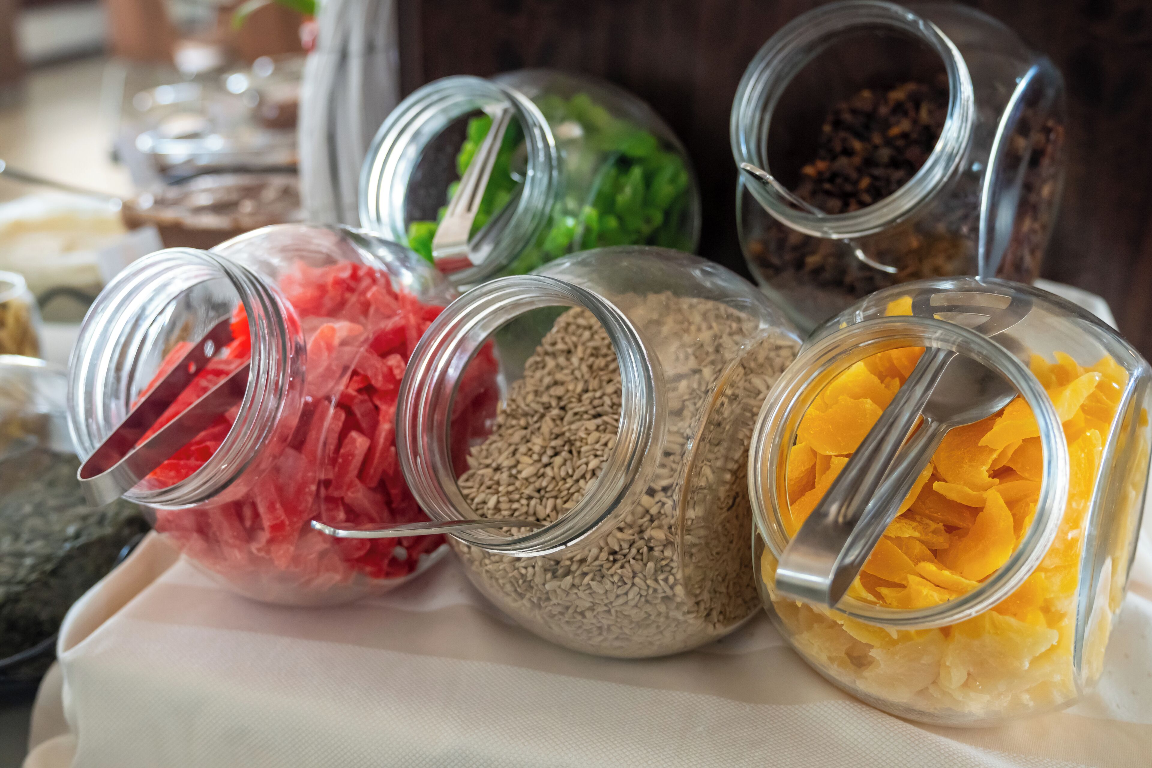 A variety of glass jars containing different food items.