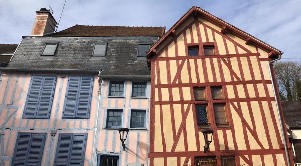 A traditional half-timbered building with a sloped roof and multiple windows.