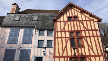 A traditional half-timbered building with a sloped roof and multiple windows.
