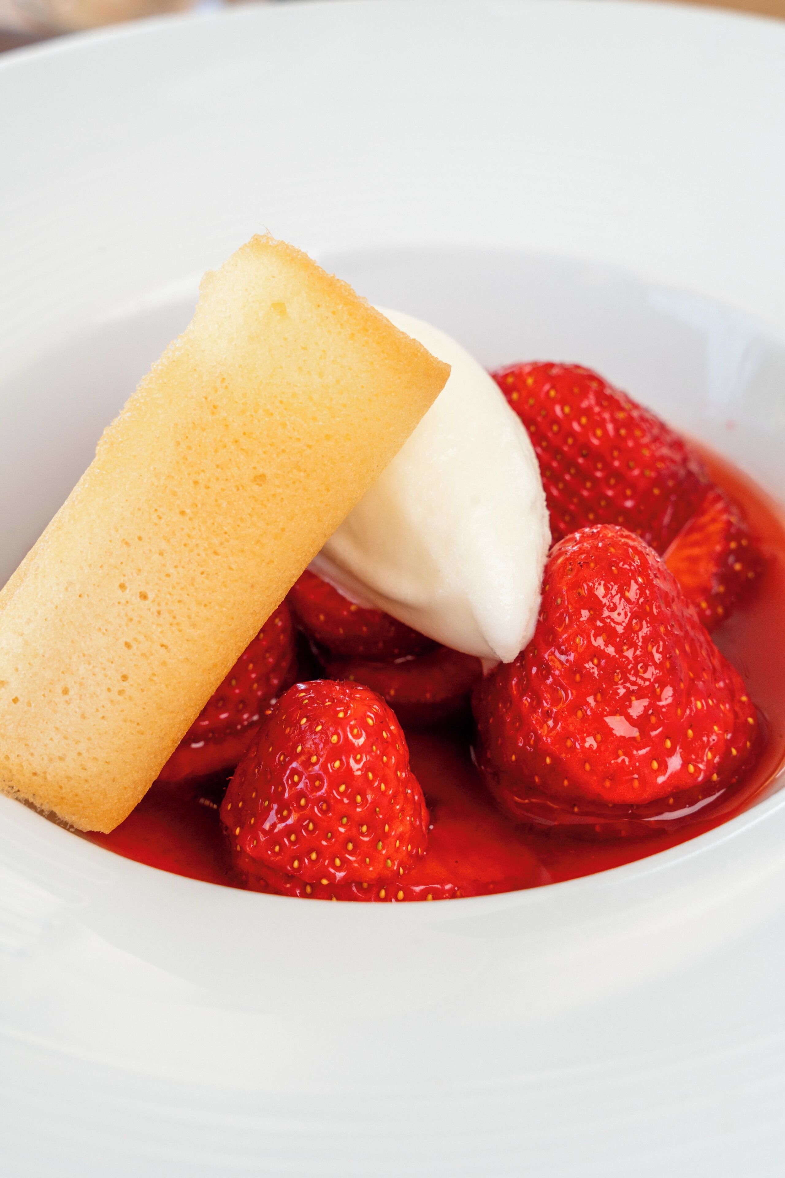 A dessert with strawberries and a piece of cake.