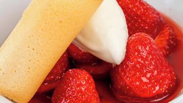 A dessert with strawberries and a piece of cake.