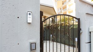 A gated entrance with a security keypad and intercom. - Domus Arena (Rome)