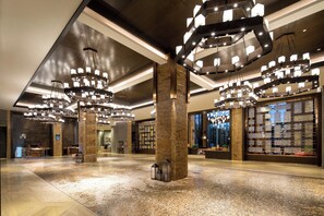 A spacious lobby with multiple light fixtures and a reception desk. - Crowne Plaza Resort Changbaishan Hot Spring by IHG (Yanbian)