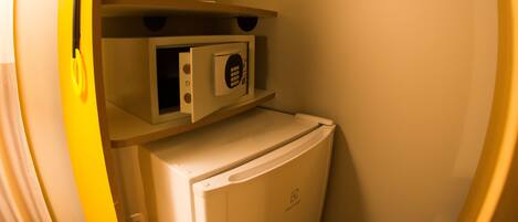 A compact kitchenette with a microwave and a refrigerator.