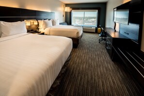 A hotel room with two beds, a TV, a desk, and a large window with a city view. - Holiday Inn Express North Augusta by IHG (North Augusta)