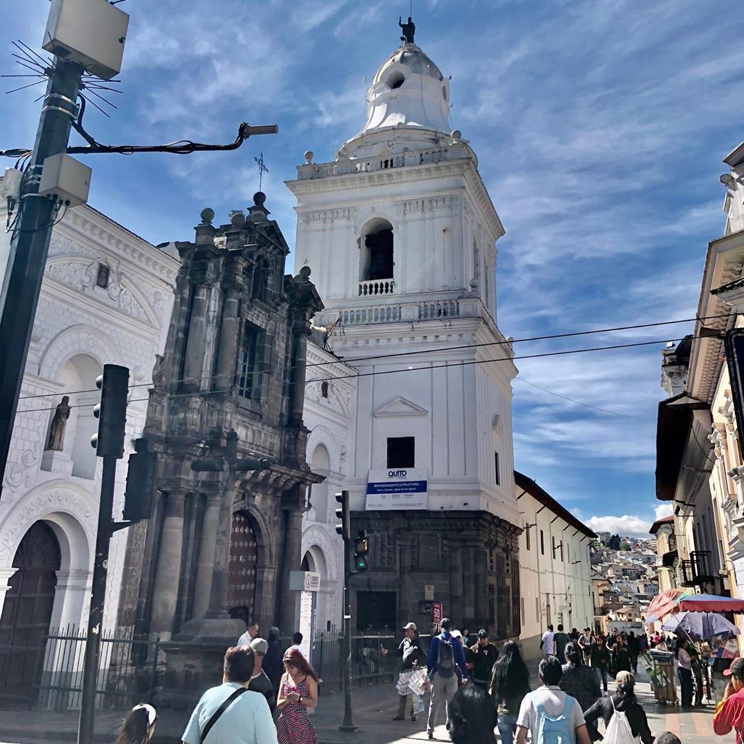 A historic building with a prominent bell tower and a large arched entrance.