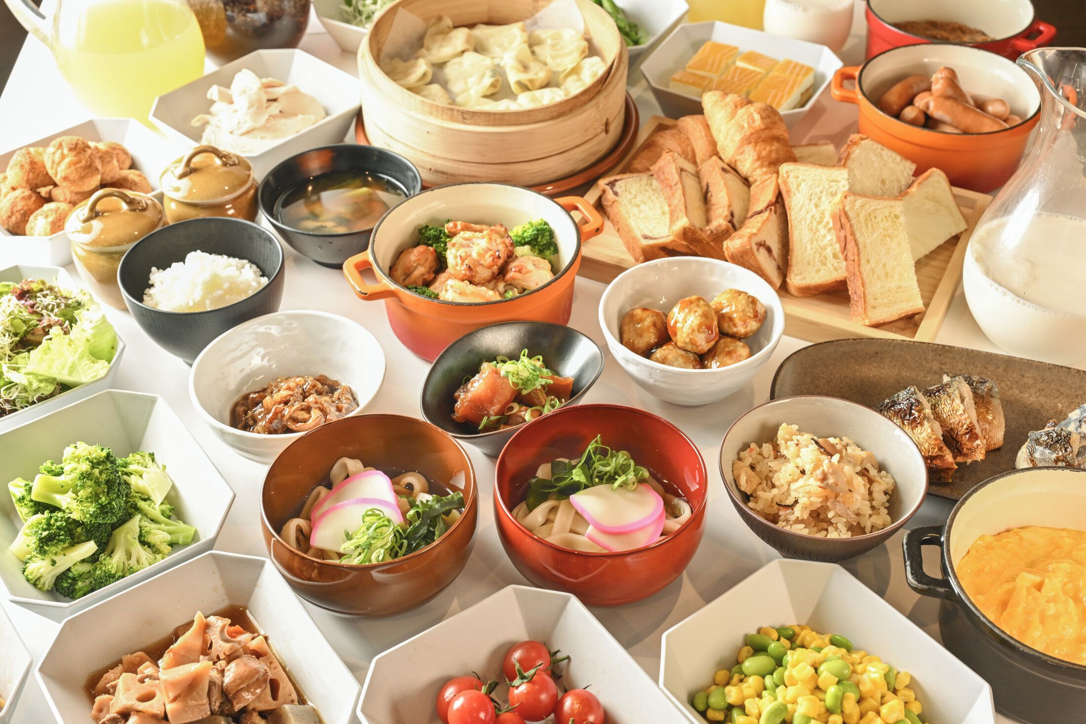 A variety of dishes including dumplings, rice, and vegetables.